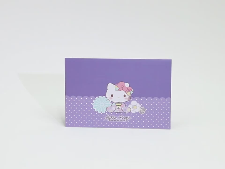 A small pop out card with purple features, and hello kitty wearing a kimono 