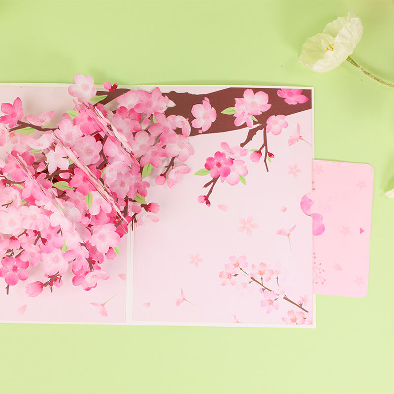 Top view and message note of peach blossom card